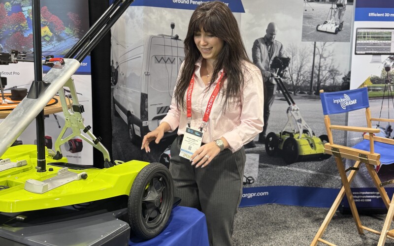 Sahar Kamalou inspects a ground penetrating radar platform at a Geo Week exhibitor.